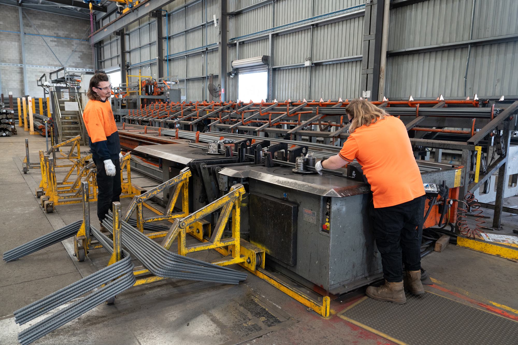 Bianco team member guiding a crane lift of reinforcing mesh in the factory